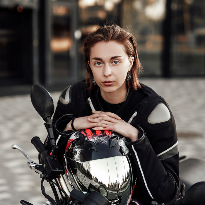 confident-girl-in-a-motorcycle-jacket-sits-with-a-MRXYCSZ